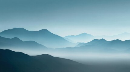 Serene Mountain Range Landscape with Layers of Blue Hues and Atmospheric Mist for Background Use