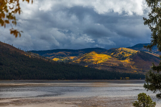 Mountain lake with autumn mountains in dramatic lighting