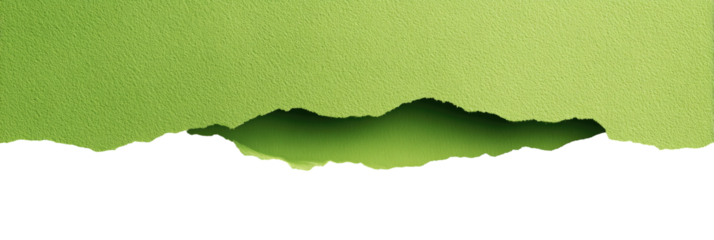 Torn green textured paper reveals dark shadowed landscape