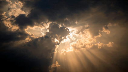 Dramatic golden light through dark clouds