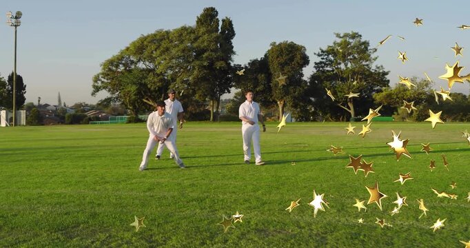 Three cricket players stooping picking red ball running bowling training under gold stars by them