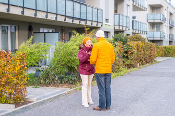 Mature couple in warm autumn jackets arguing on city street, emotional conversation, relationship tension, misunderstanding, conflict, communication issues, outdoor lifestyle, He said, she shouted