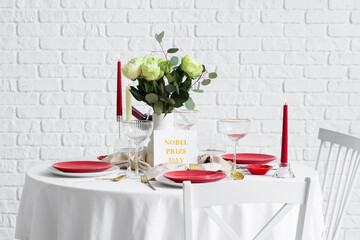 Elegant table setting for Nobel prize day with flowers and candles in dining room