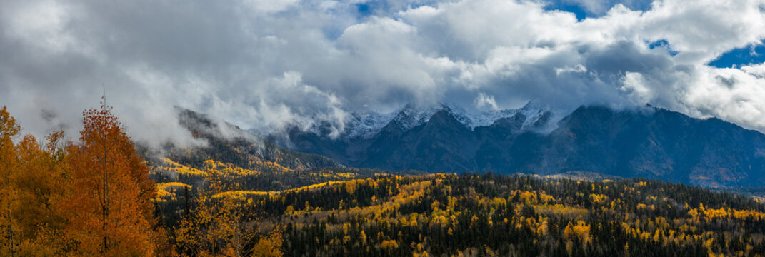 Snow dusted mountains with golden aspen trees