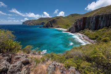 Fototapeta premium A scenic coastal view with a turquoise bay nestled between lush green hills and cliffs