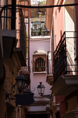 Morning sun shines on the dense streets of the Santa Cruz neighborhood of Seville, Andalusia, Spain.