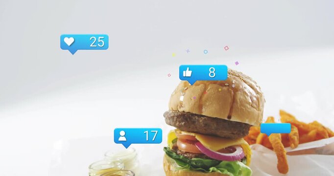 Blue badge popping, sesame burger rising, badges floating, hand placing fries, showing product