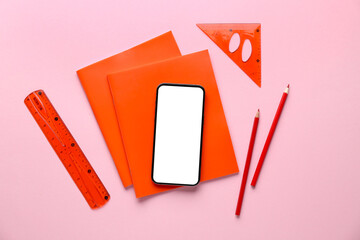 Set of school stationery and mobile phone on pink background