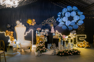 Quinceañera party decoration with neon 15 and throne chair