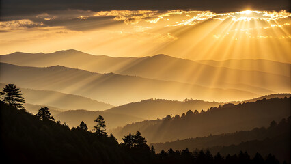 Golden sunbeams illuminate layered mountain range at sunset
