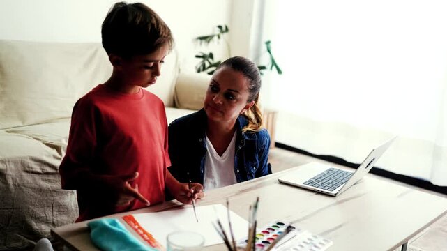 Hispanic mother helping her son with math homework at home - Homeschooling, family and education concept