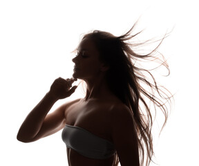 Silhouette of beautiful woman with waving hair on white background