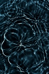 Blue water with ripples on the surface. Defocus blurred transparent blue colored clear calm water surface texture with splashes and bubbles. Water waves with shining pattern texture background.