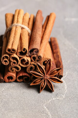 Anise star and cinnamon on grey background, closeup