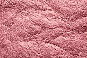 Texture of pink crumpled paper, closeup