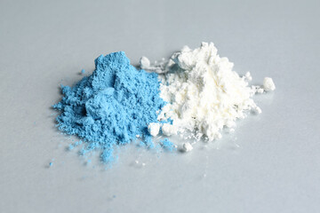 Heaps of color powder pigments on grey background