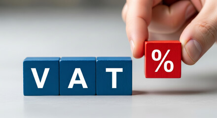 Hand arranging VAT block for international wealth tax percentage. concept about finance government and business economy