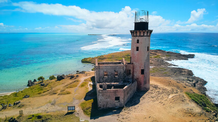 A stunning aerial view of &Icirc;le aux Fouquets National Park in Mauritius, featuring an old ruined lighthouse on the island with panoramic views of the surrounding turquoise waters and lush landscapes.