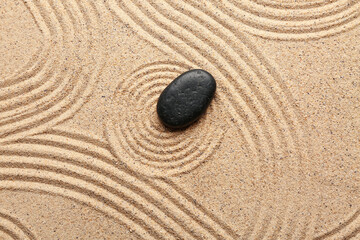Zen stone on sand with pattern