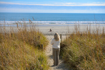 A young mother watches her son play in the sand along the Grand Strand at Myrtle Beach, South...