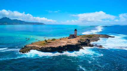 A stunning aerial view of &Icirc;le aux Fouquets National Park in Mauritius, featuring an old ruined lighthouse on the island with panoramic views of the surrounding turquoise waters and lush landscapes.