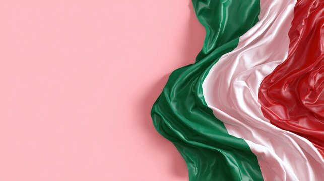 A close-up of Italian flag fabric draped elegantly against a soft pink background, showcasing vibrant green, white, and red colors.