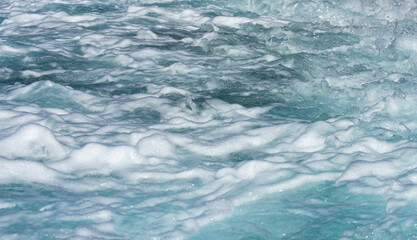 Waves ocean texture. Ocean waves move. Foamy sea wave with oceanic power. Sea waves in tropical sunshine. Crystal wave reflect light. Sea waves curl and break on the coast.