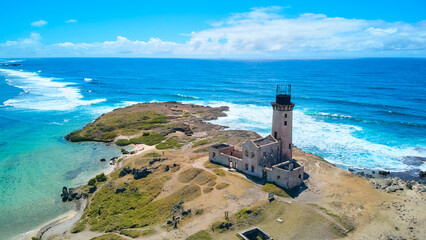 A stunning aerial view of &Icirc;le aux Fouquets National Park in Mauritius, featuring an old ruined lighthouse on the island with panoramic views of the surrounding turquoise waters and lush landscapes.
