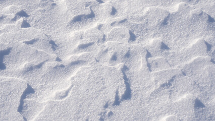 Background of snowy field. Winter snow. Snow texture top view of the snow. Winter texture. Snowy white texture. Snowflakes. Textured plain white snow background.