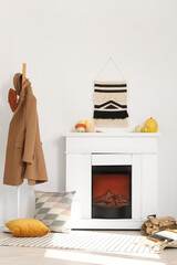 Fototapeta premium Interior of living room with fireplace, pumpkins and rack