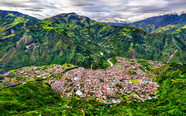 Panoramic aerial view of Banos de Agua Santa in Ecuador. Scenic landscape features town nestled in...