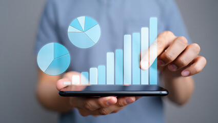 A person holding a smartphone with a digital interface showing pie charts and bar graphs representing data analysis and business growth