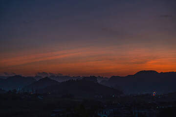 Serene twilight view of distant mountains under a vibrant gradient sky showcasing nature's beauty