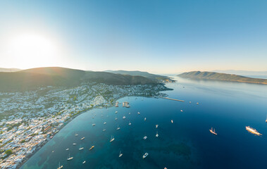 Bodrum, Turkey. Morning panoramic view of white houses, bay with yachts, forested mountains, beaches and islands in haze. Aerial view