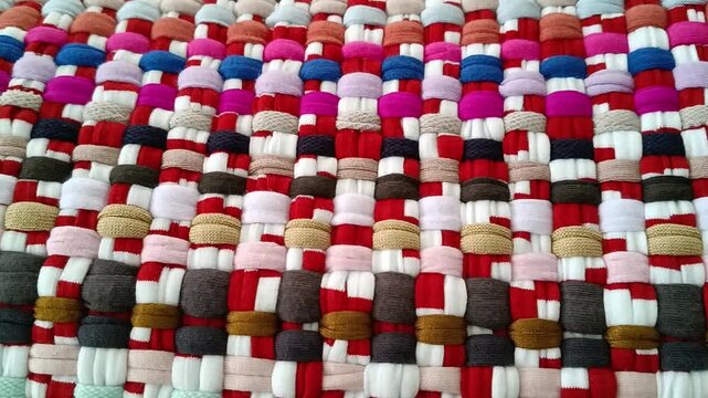 Colorful handwoven rag rug texture close-up.