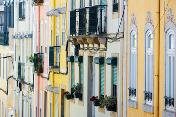Exterior architecture of colorful attached historic building in Alfama district, Lisbon, Portugal.