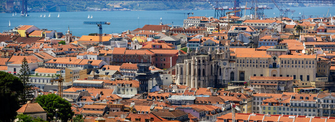 Panoramic aerial view of Lisbon cityscape, colorful buildings with red roofs in Portugal, during sunny day