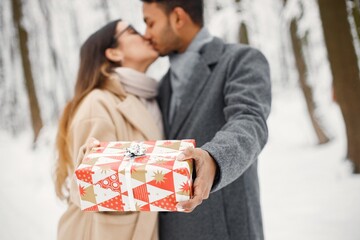 Portrait of a romantic couple spending time together in winter forest