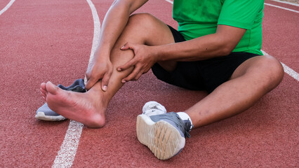 Young adult male with his muscle pain during running. runner man having leg ache due to Shin Splints. Sports injuries and medical concept © vincent27