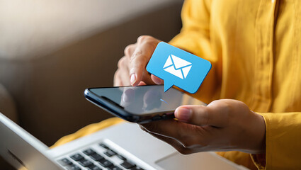 Person in Yellow Shirt Holding Smartphone with Email Notification blue envelope