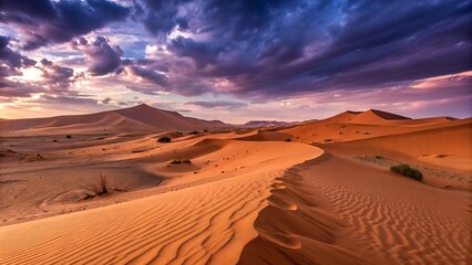 Dramatic sunset over vast orange sand dunes in the desert landscape with intense purple and dark clouds in the sky