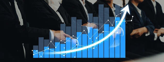 A group of business professionals at a conference, engaged in analyzing growth trends through data visualization, reflects teamwork and strategy in modern corporate culture. Scalp