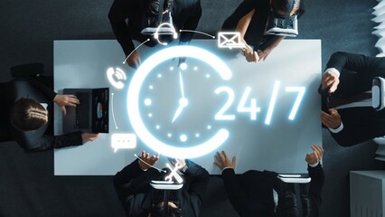 A diverse business team collaborates in a modern office environment, emphasizing 24-hour availability and digital communication tools to enhance productivity and teamwork. Raster