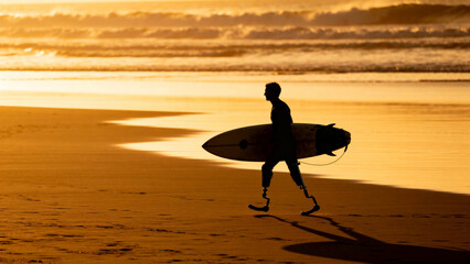 Amputee Surfer Walking to the Ocean at Sunset – Disability, Freedom and Passion