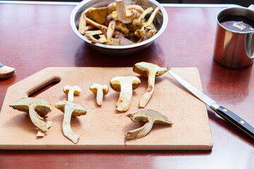 Cut mushrooms lie on wooden board