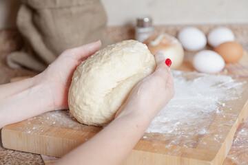 Piece of dough in female hands
