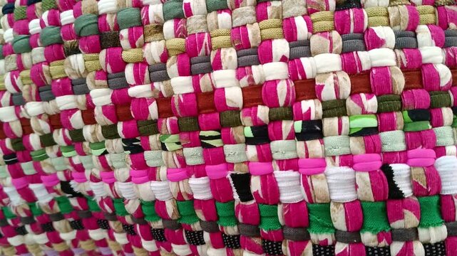 Colorful handwoven rag rug texture close-up.