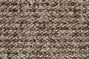 A close-up of a modern carpet sample. Brown carpet texture