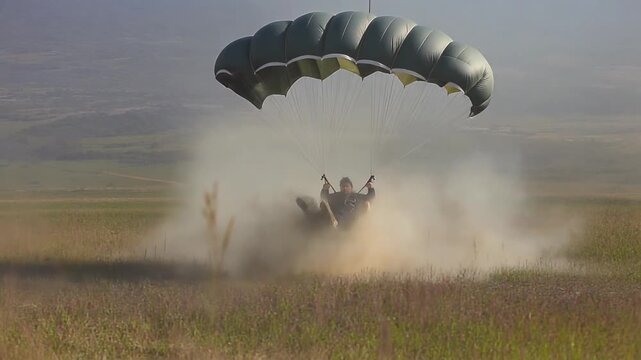a parachutist making a smooth landing on an open field