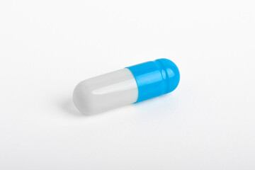One pill capsule isolated on white background. Medicinal treatment